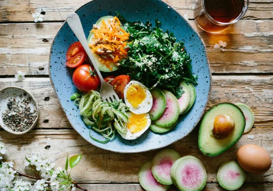 A plate of vegetables, eggs and avocado