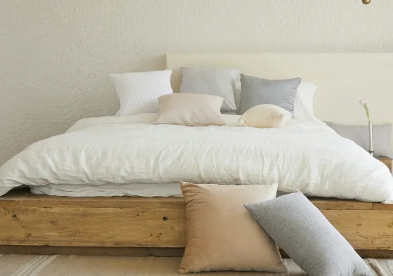 An unmade bed with white linen